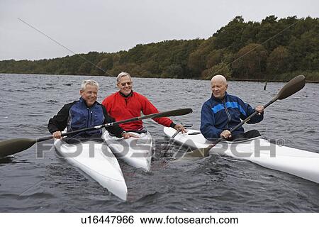 Stock Photograph - Three Middle-Aged Men Kayaking. Fotosearch