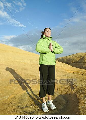 Woman meditating on rocky hill View Large Photo Image Stock Image - Woman meditating on rocky hill. Fotosearch