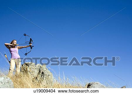 Young woman arrow shooting View Large Photo Image Picture - Young woman arrow shooting. Fotosearch