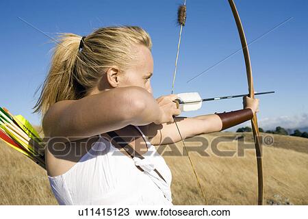 Young woman arrow shooting View Large Photo Image Stock Image - Young woman arrow shooting. Fotosearch