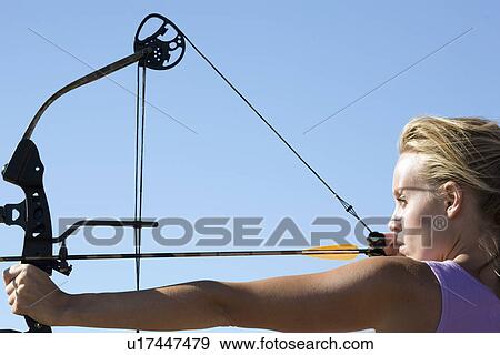 Young woman arrow shooting View Large Photo Image Stock Photo - Young woman arrow shooting. Fotosearch