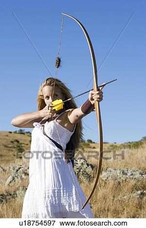 Young woman arrow shooting View Large Photo Image Stock Photo - Young woman arrow shooting. Fotosearch