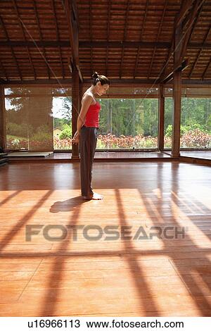 Young woman contemplating and standing on wooden floor View Large Photo Image Stock Image - Young woman contemplating and standing on wooden floor. Fotosearch