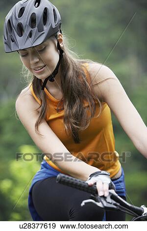 Young woman cycling View Large Photo Image Stock Photo - Young woman cycling. Fotosearch