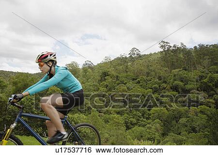 Young woman riding mountain bike View Large Photo Image Stock Photograph - Young woman riding mountain bike. Fotosearch