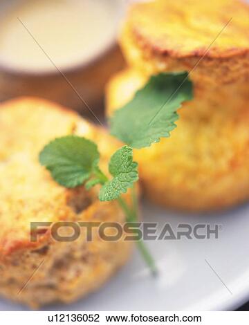 Stock Image - Apple Mint Surrounded By Scones, High Angle View, Differential Focus. Fotosearch