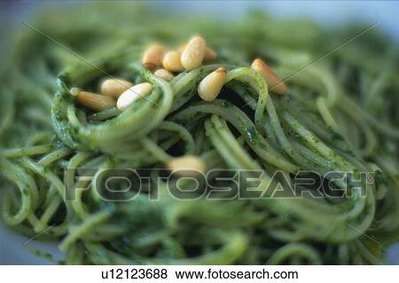 Stock Photo - Basil Spaghetti WithPine Seeds on Top, Front View, Differential Focus. Fotosearch