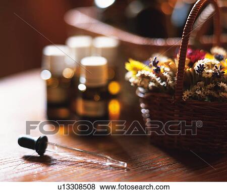 Several Bottles of Aromatherapy, Next to a Basket Filled With Herbs, Side View, Differential Focus View Large Photo Image Stock Photo - Several Bottles of Aromatherapy, Next to a Basket Filled With Herbs, Side View, Differential Focus. Fotosearch