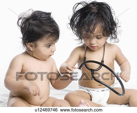 Close-up of a baby boy and his sister playing with a stethoscope View Large Photo Image Stock Photograph - Close-up of a baby boy and his sister playing with a stethoscope. Fotosearch