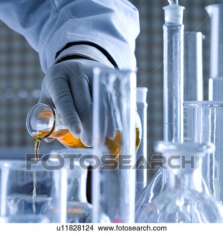 Close-up of a scientist pouring chemicals View Large Photo Image Picture - Close-up of a scientist pouring chemicals. Fotosearch