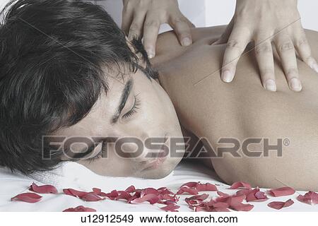 Stock Photo - Close-up of a young man getting a back massage. Fotosearch