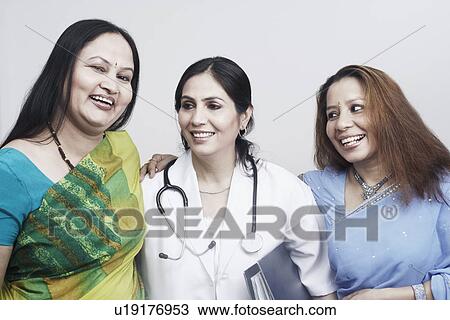 Stock Image - Close-up of three women smiling. Fotosearch