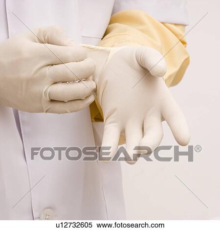 Mid section view of a male doctor wearing surgical gloves View Large Photo Image Stock Photography - Mid section view of a male doctor wearing surgical gloves. Fotosearch