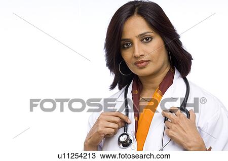 Stock Image - Portrait of a female doctor holding a stethoscope. Fotosearch