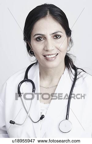 Stock Photo - Portrait of a female doctor smiling. Fotosearch