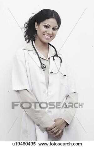 Stock Photography - Portrait of a female doctor standing with a stethoscope around her neck. Fotosearch