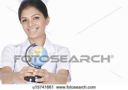Portrait of a female nurse holding a globe View Large Photo Image Stock Image - Portrait of a female nurse holding a globe. Fotosearch
