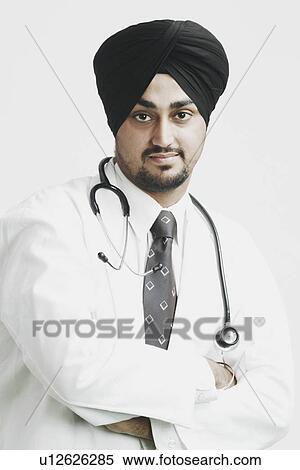 Portrait of a male doctor standing with his arms crossed View Large Photo Image Stock Photography - Portrait of a male doctor standing with his arms crossed. Fotosearch