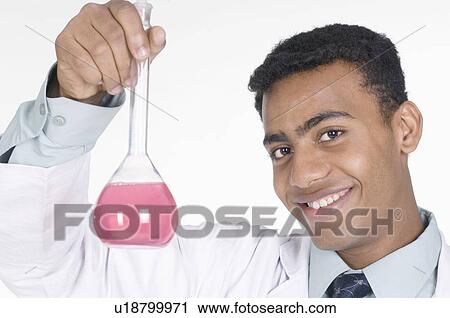 Portrait of a male technician holding a conical flask View Large Photo Image Stock Image - Portrait of a male technician holding a conical flask. Fotosearch