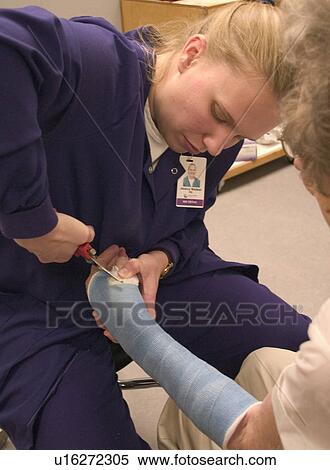 Clinic nurse making adjustments to cast with cutter for elderly patient with a broken wrist age 28 and 90. Plymouth Minnesota View Large Photo Image Stock Photography - Clinic nurse making adjustments to cast with cutter for elderly patient with a broken wrist age 28 and 90. Plymouth Minnesota. Fotosearch