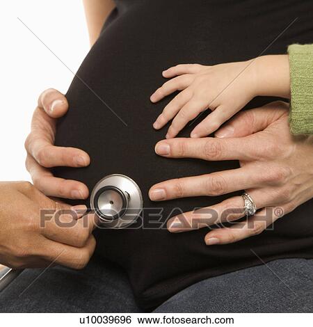 Nurse holding stethoscope to Caucasian pregnant woman's belly. View Large Photo Image Stock Photograph - Nurse holding stethoscope to Caucasian pregnant woman's belly.. Fotosearch