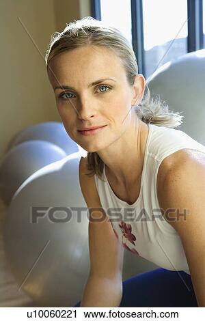 Stock Image - Portrait of prime adult female Caucasian at gym.. Fotosearch