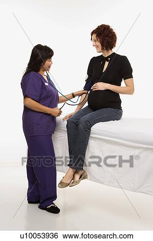Pregnant Caucasian mid-adult woman having vital signs checked by nurse. View Large Photo Image Stock Photograph - Pregnant Caucasian mid-adult woman having vital signs checked by nurse.. Fotosearch