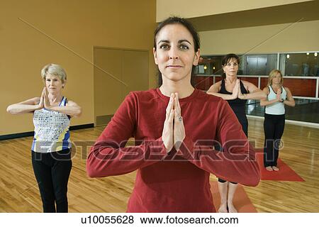 Stock Photo - Prime adult female Caucasians in yoga class.. Fotosearch