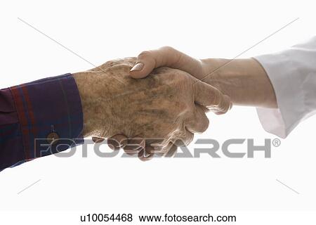 Stock Photo - Close-up of elderly Caucasian male shaking hands with mid-adult Caucasian female hand.. Fotosearch