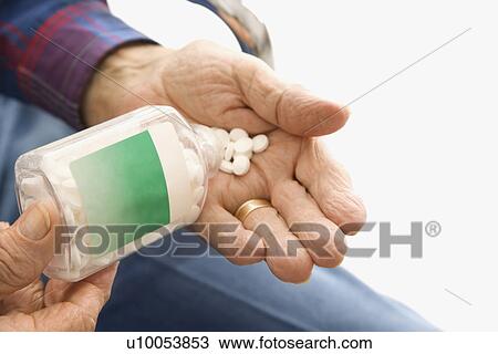 Close-up of elderly male Caucasio pouring pills into hand. View Large Photo Image Stock Image - Close-up of elderly male Caucasio pouring pills into hand.. Fotosearch