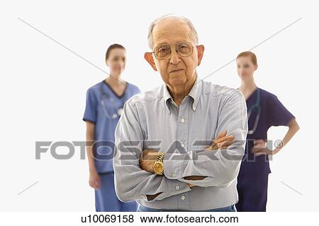 Elderly Caucasian male in foreground with two Caucasian females in the background. View Large Photo Image Stock Photo - Elderly Caucasian male in foreground with two Caucasian females in the background.. Fotosearch
