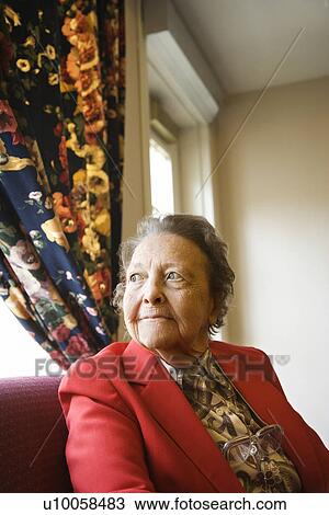 Elderly Caucasian woman by window at retirement community center. View Large Photo Image Stock Image - Elderly Caucasian woman by window at retirement community center.. Fotosearch
