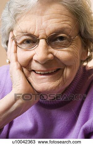Elderly Caucasian woman smiling with hand on face. View Large Photo Image Stock Image - Elderly Caucasian woman smiling with hand on face.. Fotosearch