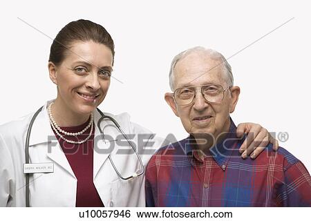 Stock Photograph - Mid-adult Caucasian female doctor with arm around elderly Caucasian male.. Fotosearch