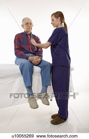 Mid-adult Caucasian female in scrubs listening to elderly Caucasian male's heart beat. View Large Photo Image Stock Photo - Mid-adult Caucasian female in scrubs listening to elderly Caucasian male's heart beat.. Fotosearch