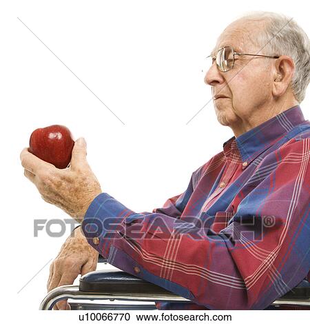 Profile of Caucasion elderly man sitting in wheelchair looking at red apple in his hand. View Large Photo Image Stock Image - Profile of Caucasion elderly man sitting in wheelchair looking at red apple in his hand.. Fotosearch