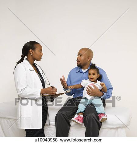 African-American father holding baby girl talking to female pediatrician. View Large Photo Image Stock Photo - African-American father holding baby girl talking to female pediatrician.. Fotosearch