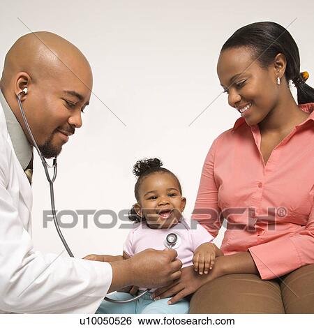 African-American male pediatrician examining baby girl being held by mother. View Large Photo Image Stock Photograph - African-American male pediatrician examining baby girl being held by mother.. Fotosearch