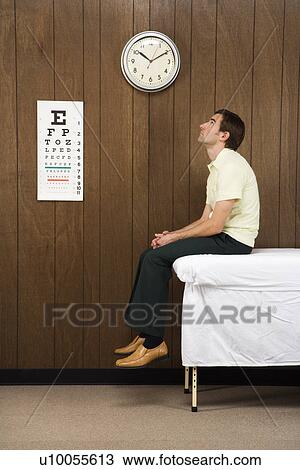 Caucasian mid-adult male waiting on table in retro doctor's office. View Large Photo Image Stock Image - Caucasian mid-adult male waiting on table in retro doctor's office.. Fotosearch