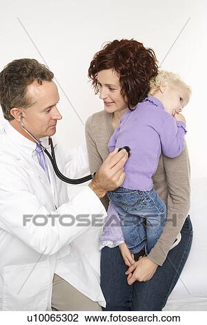 Caucasian mid-adult mother holding her female toddler while middle-aged male doctor uses stethoscope. View Large Photo Image Stock Image - Caucasian mid-adult mother holding her female toddler while middle-aged male doctor uses stethoscope.. Fotosearch