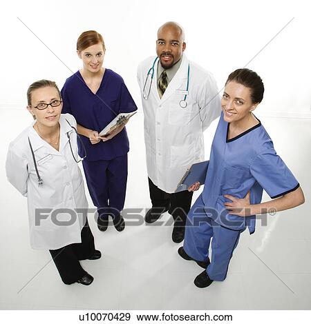 Stock Photograph - Full-length portrait of African-American man and Caucasian women medical healthcare workers smiling in uniforms standing against white background.. Fotosearch - Search Stock Photography, Posters, Pictures, and Photo Clipart Images