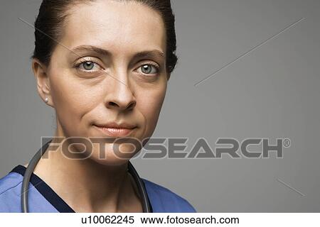 Head shot portrait of Caucasian woman doctor against gray background. View Large Photo Image Stock Photography - Head shot portrait of Caucasian woman doctor against gray background.. Fotosearch
