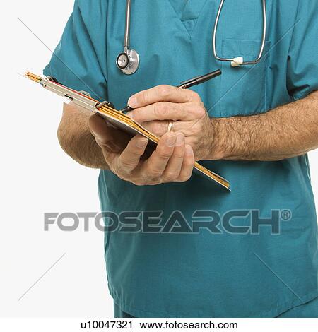 Stock Image - Mid-adult Caucasian male doctor taking notes on a patient's chart.. Fotosearch
