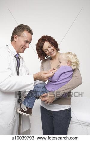 Middle-aged adult Caucasian male doctor comforting Caucasian female toddler. View Large Photo Image Stock Image - Middle-aged adult Caucasian male doctor comforting Caucasian female toddler.. Fotosearch