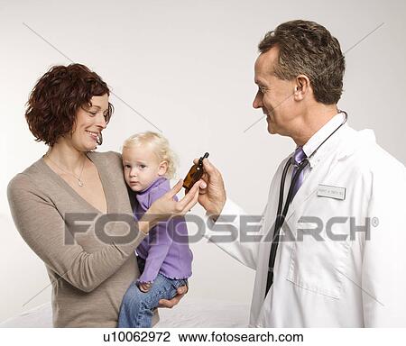 Middle-aged adult Caucasian male doctor handing Caucasian mother medication in a bottle. View Large Photo Image Stock Image - Middle-aged adult Caucasian male doctor handing Caucasian mother medication in a bottle.. Fotosearch