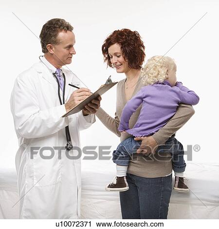 Middle-aged adult Caucasian male doctor taking notes on chart as mother holds daughter. View Large Photo Image Stock Image - Middle-aged adult Caucasian male doctor taking notes on chart as mother holds daughter.. Fotosearch