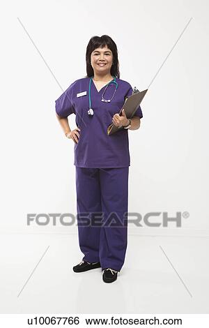 Middle-aged Filipino woman dressed in scrubs with stethoscope and clipboard. View Large Photo Image Stock Photograph - Middle-aged Filipino woman dressed in scrubs with stethoscope and clipboard.. Fotosearch