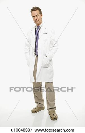 Studio shot of a mid-adult Caucasian male doctor with hands in lab coat pockets. View Large Photo Image Stock Photo - Studio shot of a mid-adult Caucasian male doctor with hands in lab coat pockets.. Fotosearch