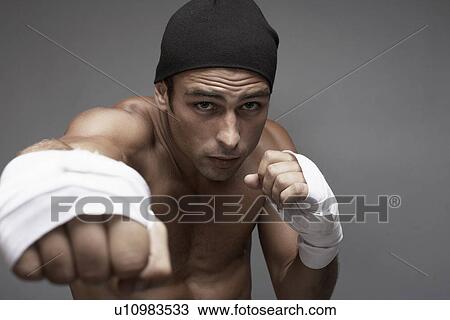 Stock Image - Boxer punching. Fotosearch