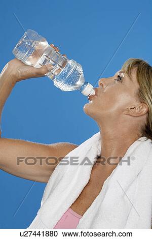 Fit mature woman drinking water View Large Photo Image Stock Image - Fit mature woman drinking water. Fotosearch